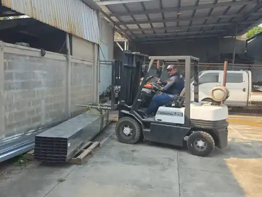 Forklift moving steel beams